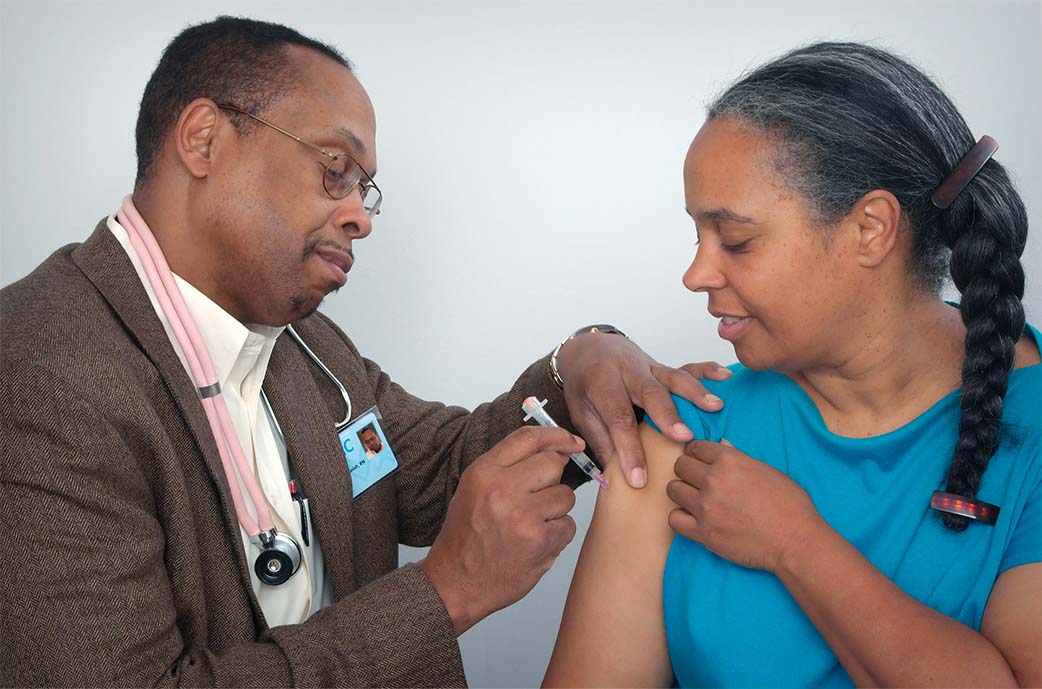 doctor giving a vaccine to patient